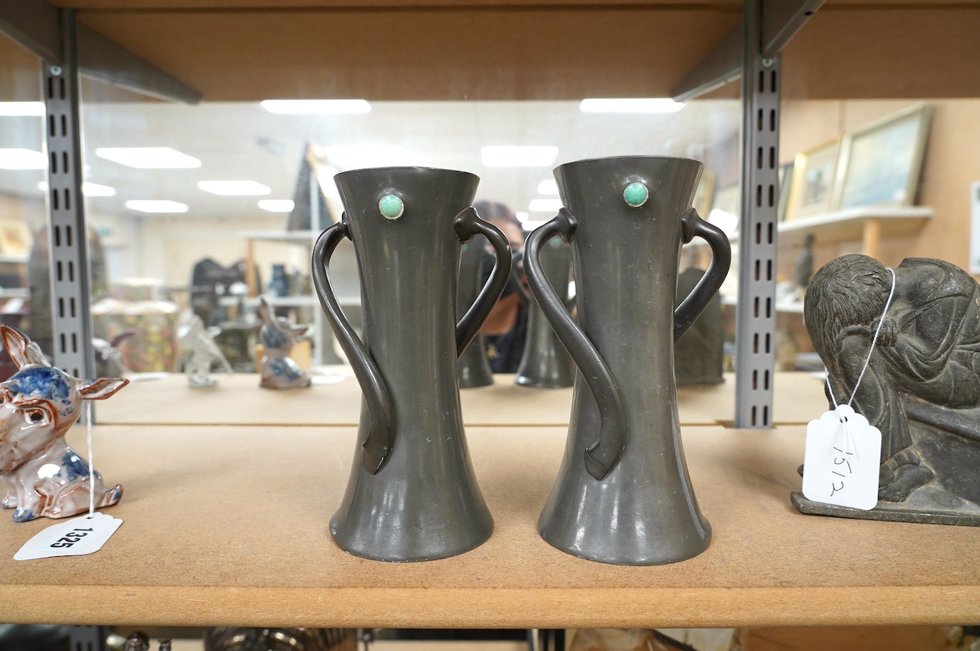 Two Liberty Tudric pewter vases with enamel cabochons, model no. 030, largest 19cm high. Condition - fair, one dented